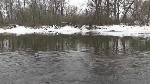 river flows in early spring, snow shore
