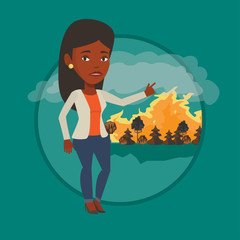 Woman standing on background of wildfire.