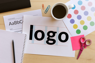 Creative graphic designer desk. Logo design concept. Flat lay