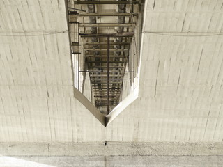 arched concrete structure under a bridge