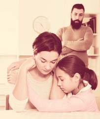 Father lecturing wife and daughter