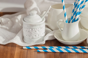 Set of white empty tableware with striped tubules