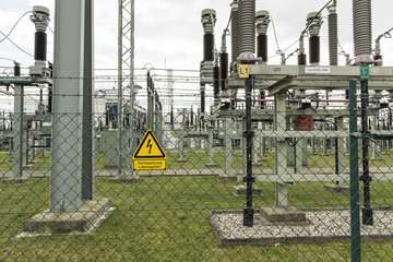 Fence of a transformer station with a yellow sign danger to life