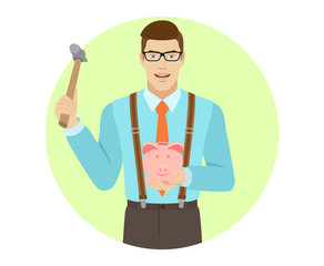 Businessman trying to break a piggy bank with a hammer