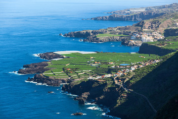 Shoreline of northern side of Tenerife island with blue Atlantic ocean. Aerial view at green plantations. The Canary, Spain, Europe