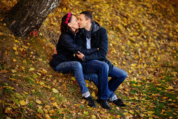 Parents look at children in autumn park