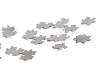 Fototapeta premium Metal puzzle pieces isolated on white