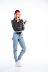 Young excited woman photographer looking at mobile phone