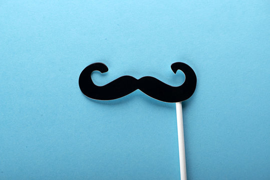 Paper mustache on blue background.