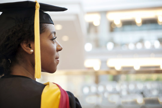 Woman in graduation gown looking away
