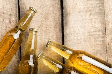 Fototapeta na wymiar Beer bottles on a wooden table .