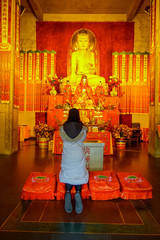 SHANGHAI, CHINA - 29 JANUARY, 2017: Religious alter in yellow and red colored theme, golden buddha statue standing at center, located at Jing'an temple traditional chinese neighborhood