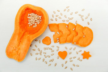 Cut Pieces of Pumpkin with Seeds on the White Table.Harvest,Fresh Vegetable, Ingredient.Food Background.Top View