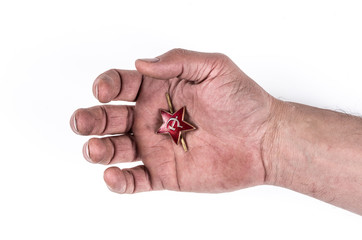 The hand of a Soviet soldier with a red star