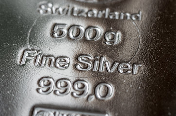 The surface of cast silver bullion. The texture of the surface of the silver bar. Selective focus.  (shallow DOF)