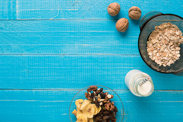 Porridge, oats, milk and banana on the table