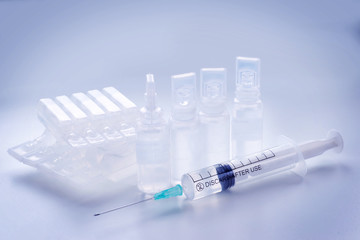 Group of plastic ampoules and syringe