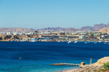 Fototapeta na wymiar Mountain resort and the sea. Sinai Peninsula, Bay of Naama Bay, Red Sea, Egypt