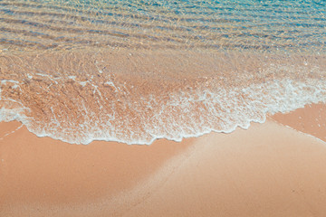 Fototapeta na wymiar Wave on the beach. Soft Wave Of Blue Ocean On Sandy Beach. Background. Selective focus.