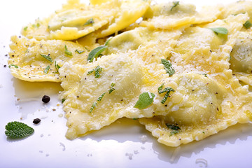 Homemade spinach and ricotta ravioli with sage butter sauce, parmesan and pepper - 141561154