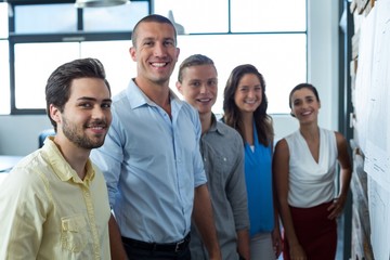Smiling business executives standing in office