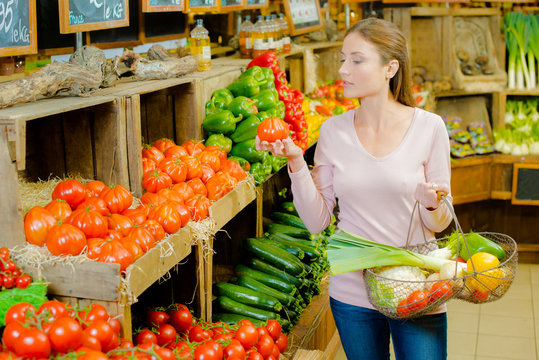 Woman choosing tomatoes
