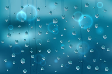Water drops on glass and on blue background