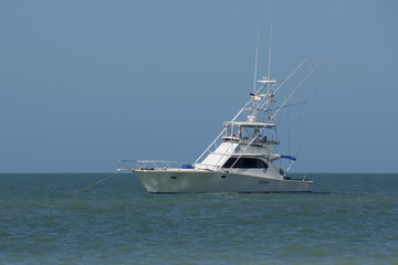 Fototapeta na wymiar A pleasure boat anchors off of St. Pete Beach, Florida on a warm sunny January afternoon.