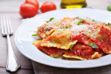 Spinach and ricotta ravioli with tomato sauce and parmesan
