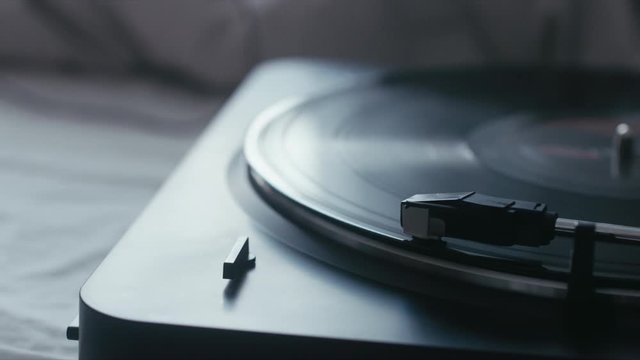 CINEMAGRAPH - seamless loop. Vinyl record is being played on a modern turntable on bed. 4K UHD RAW edited footage
