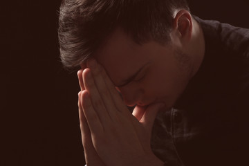 Fototapeta premium Handsome depressed man on black background