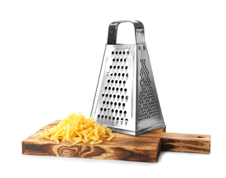 Wooden board with metal grater and cheese isolated on white