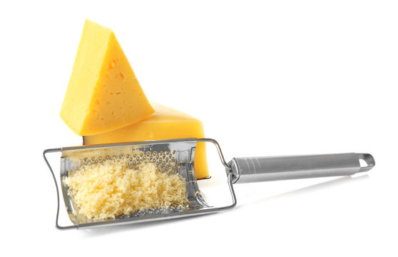 Metal grater and cheese isolated on white