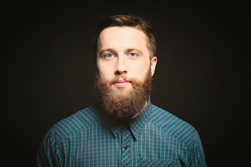 Portrait of handsome bearded man on black background