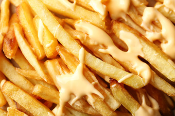 Delicious cheese fries as background