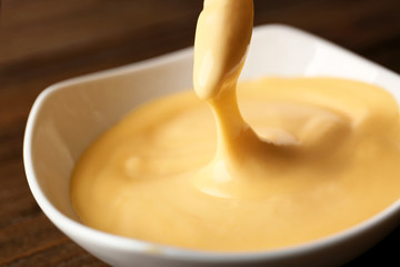 Crunchy fries with tasty cheese sauce, closeup