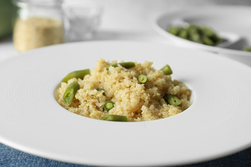 Cooked quinoa with French beans on white plate