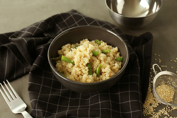 Cooked quinoa with French beans in black bowl