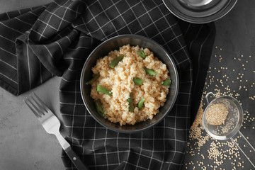 Cooked quinoa with French beans in black bowl