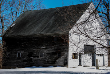 Old New England barn beneath a deep blue late winter sky