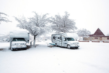 Two RV parked in a campground.