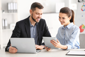 Young managers discussing issues in office