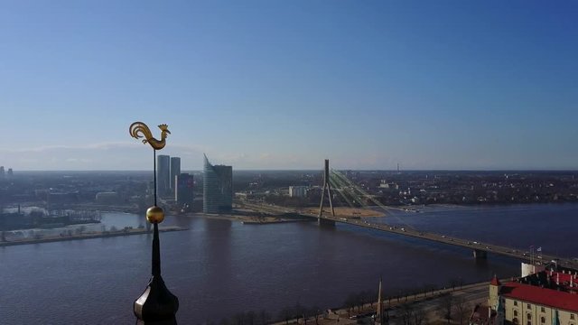 Amazing aerial view of the Riga city golden cock with Daugava river on the background.