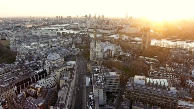 Panoramic Aerial Shot of Houses of Parliament & Big Ben in Central London features The London Eye Wheel, River Thames and Iconic Business Buildings Skycrapers with Beautiful Sunrise 4K