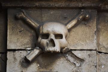 Old skull and crossbones on a wall, Porto San Giorgio, Marche region, Italy
