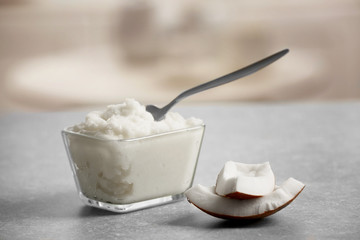 Fresh coconut oil in glassware on grey table