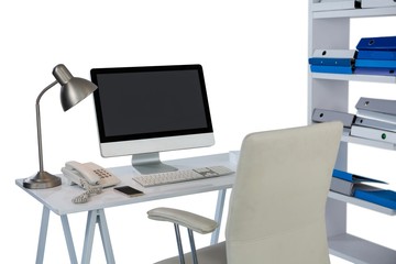 Computer with telephone and mobile phone at desk
