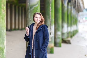 Woman portrait at low tides of Thames with green stilts