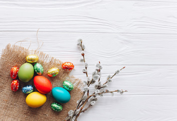  colored easter eggs and  on white wooden background