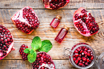sliced pomegranate on wooden background top view
